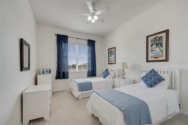 a bedroom with two beds and a chandelier