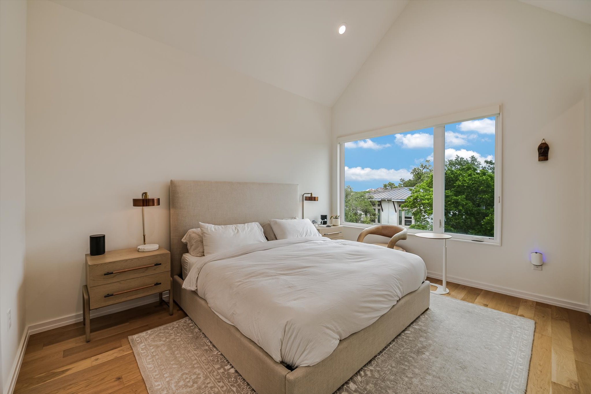 410 West Alpine Road, Unit 4 Austin, TX 78704 - Photo 11 of 24 a bedroom with a bed and large windows
