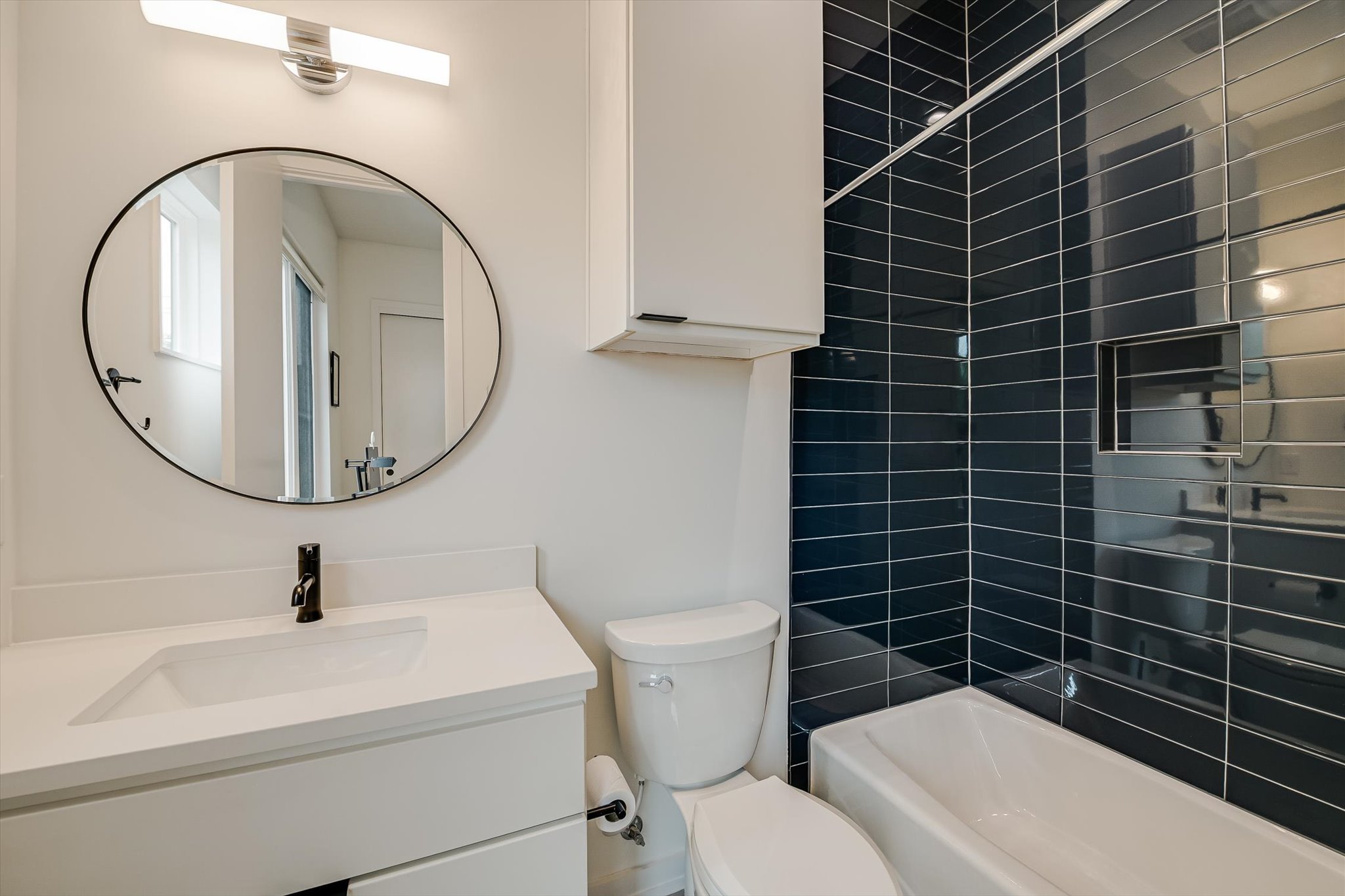 410 West Alpine Road, Unit 4 Austin, TX 78704 - Photo 15 of 24 a bathroom with a toilet a sink and a mirror