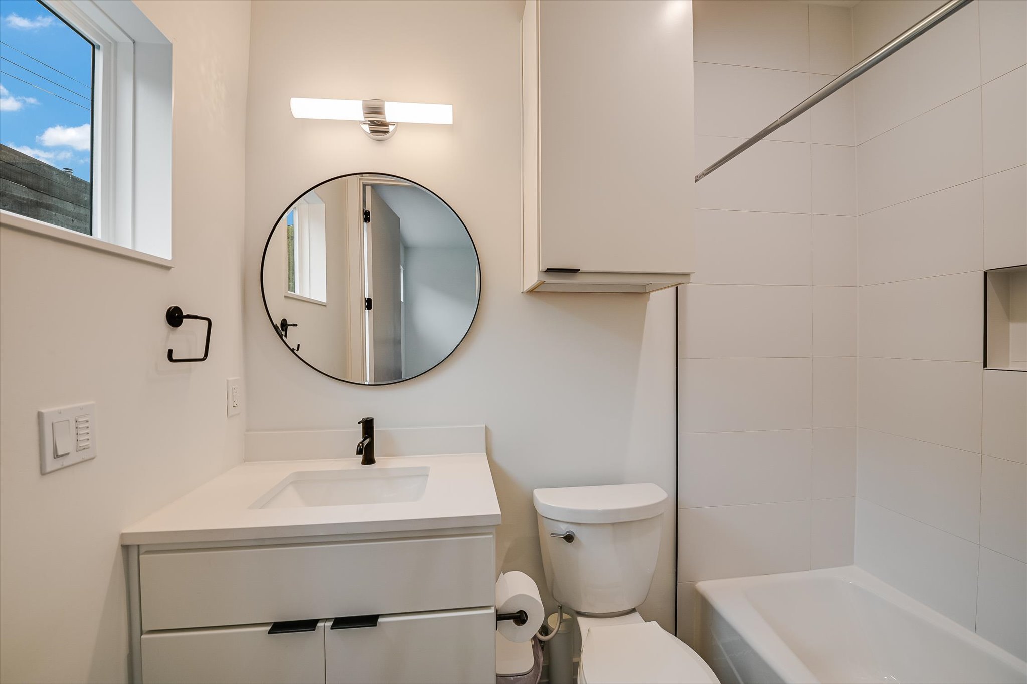 410 West Alpine Road, Unit 4 Austin, TX 78704 - Photo 17 of 24 a bathroom with a sink mirror vanity and toilet