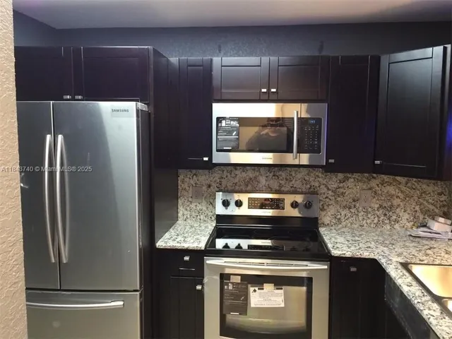 a kitchen with a stove microwave and refrigerator