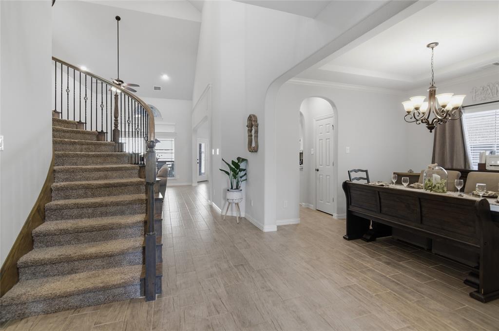 464 LeTara Ranch Drive Haslet, TX 76052 - Photo 7 of 37 Curved staircase with iron balusters and carpeted treads