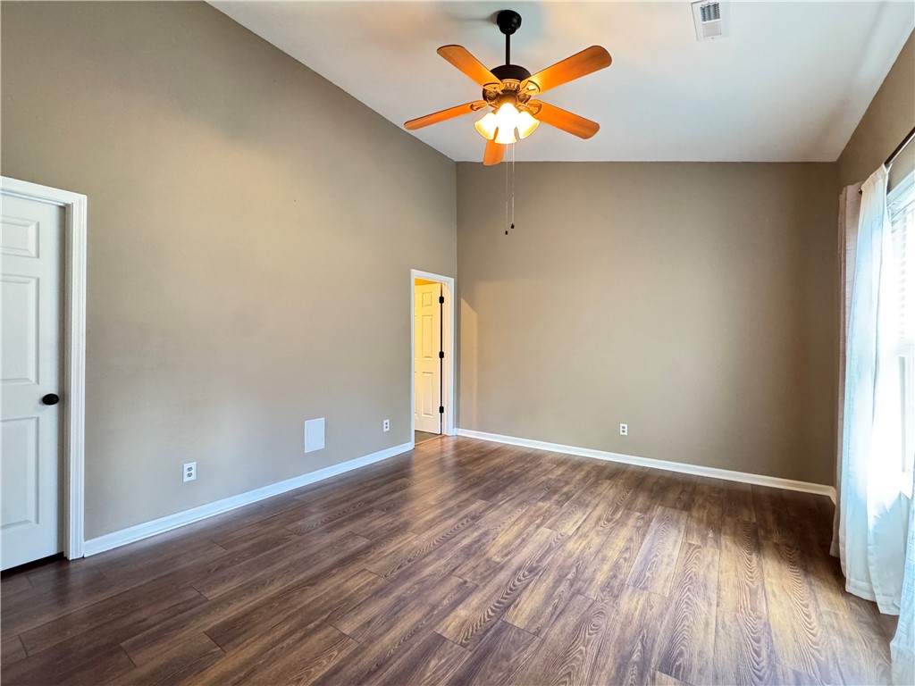 160 Wexford Drive, Unit 206 Anderson, SC 29621 - Photo 18 of 31 Vacant pic. A spacious room features a lofty ceiling and rich wood-toned flooring, bathed in natural illumination.