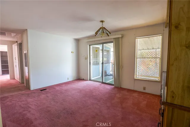 an empty room with a window and closet