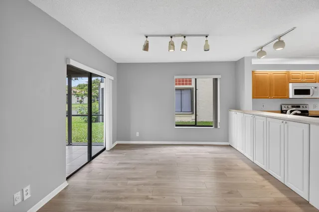 a view of a room with wooden floor and a window