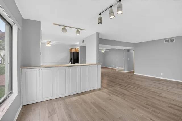 a view of a hallway with wooden floor