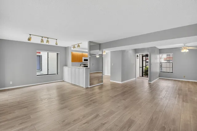 a view of a kitchen with wooden floor and electronic appliances