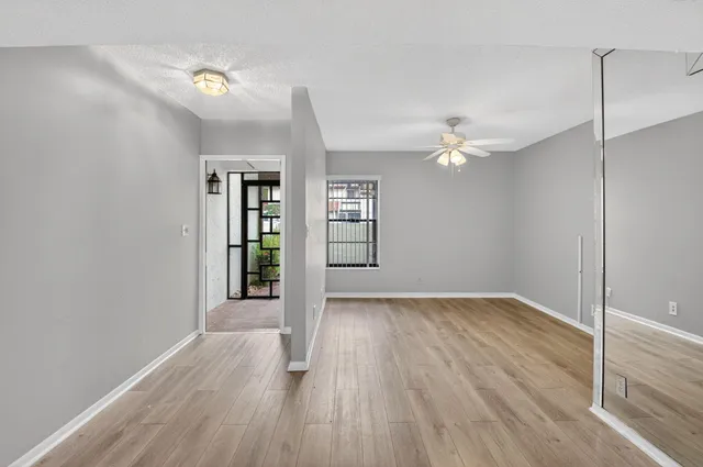 wooden floor in an empty room with a window