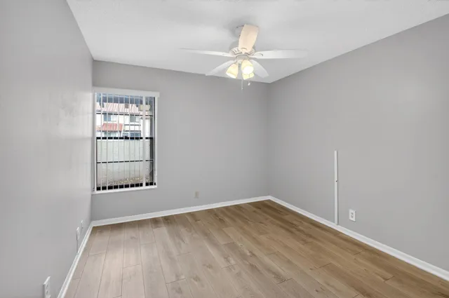 wooden floor in an empty room with a window