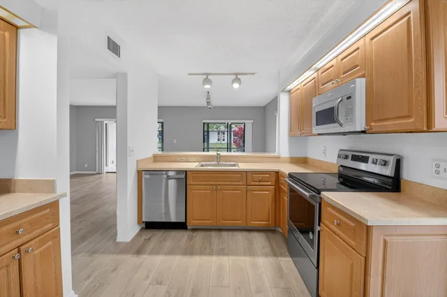 a kitchen with a stove top oven sink and cabinets