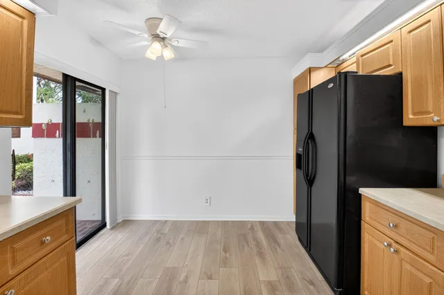 a kitchen with a refrigerator a sink and a stove top oven