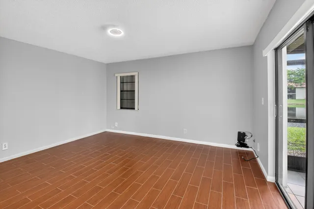 a view of a room with wooden floor and a balcony