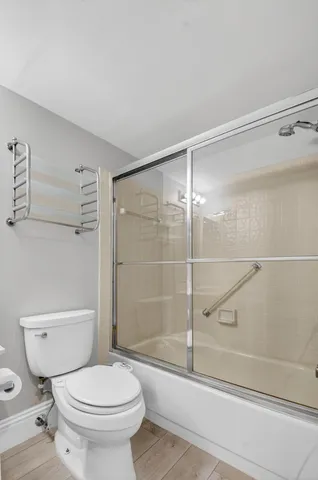 a bathroom with a toilet and a shower
