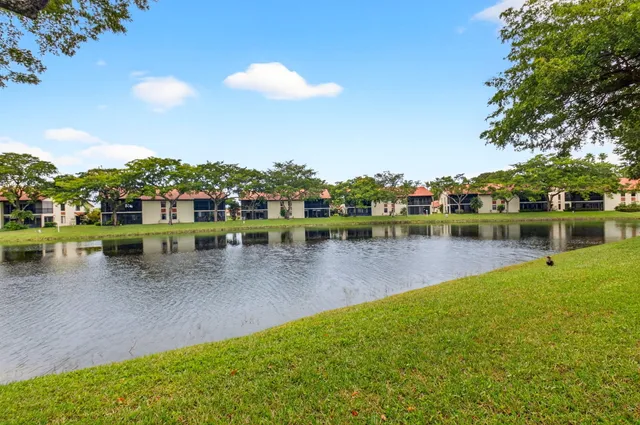 a view of a lake with houses in the back