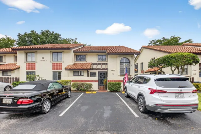 a couple of cars parked in front of a house