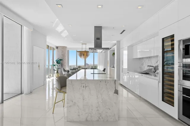 a dining room with furniture and a floor to ceiling window