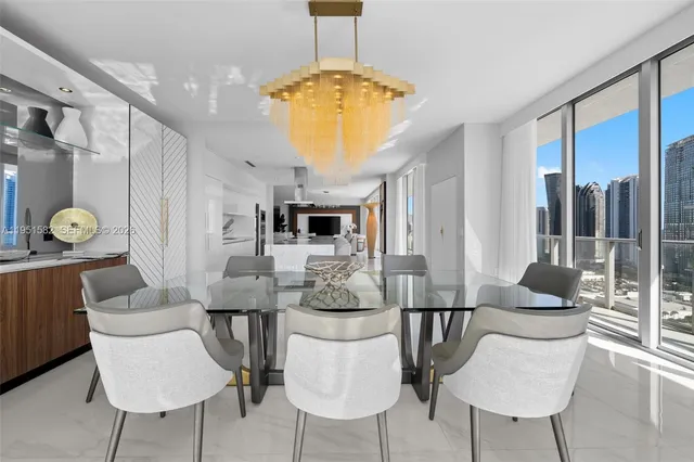 a bedroom with a large bed a flat screen tv and a large window