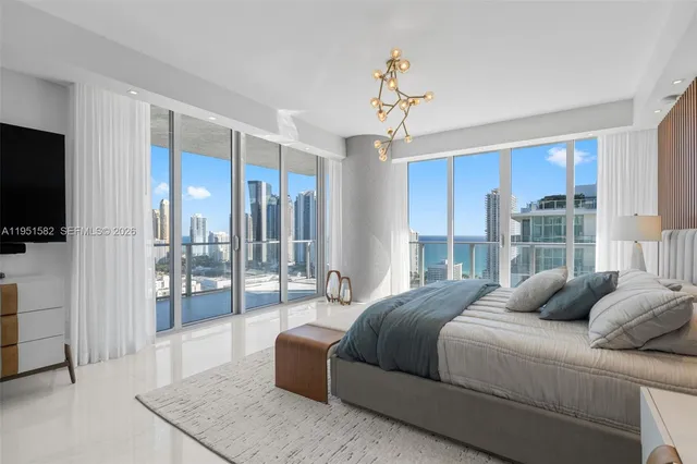 a bathroom with a double vanity sink a toilet a mirror and shower