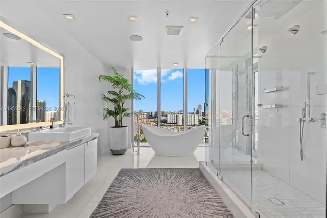 a bedroom with a large bed and flat tv screen on dresser