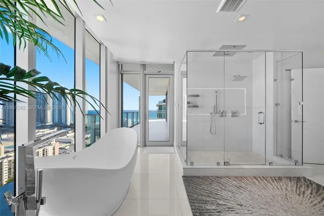 a bathroom with a granite countertop sink mirror bathtub and shower