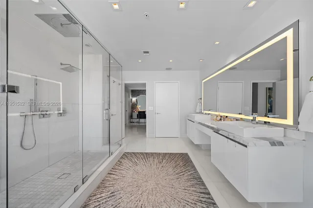 a bathroom with a tub a sink and mirror