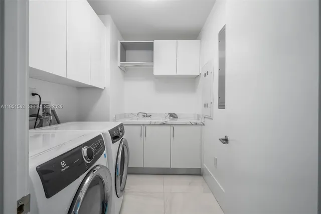 a view of a two chairs in the patio with a small yard