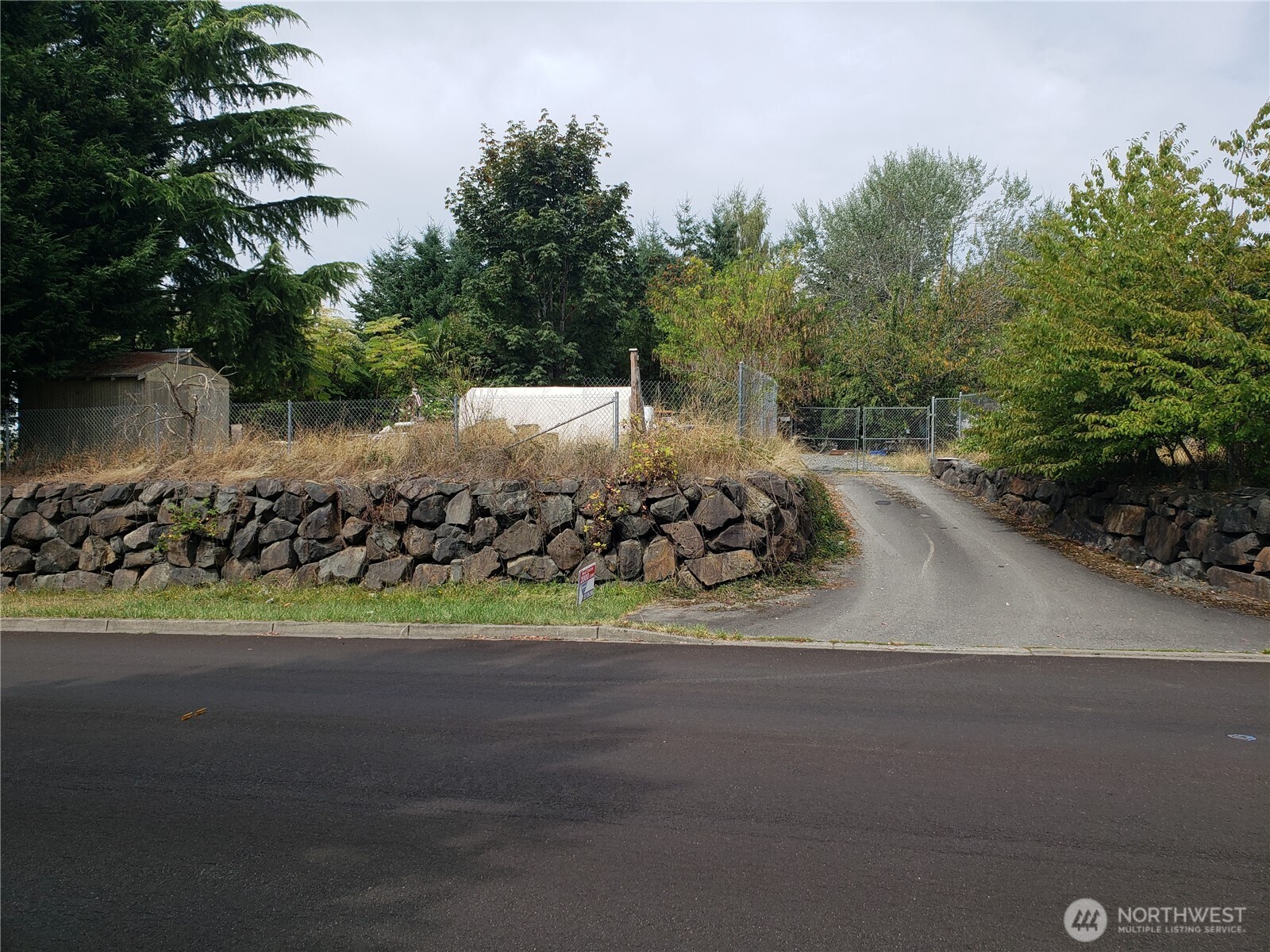 6570 Southeast 2nd Place Renton, WA 98059 - Photo 1 of 3 a view of a road with a yard and car parked