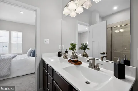 a bathroom with a sink a large mirror and vanity