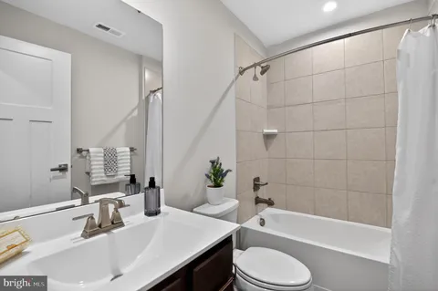 a bathroom with a sink a toilet and bathtub