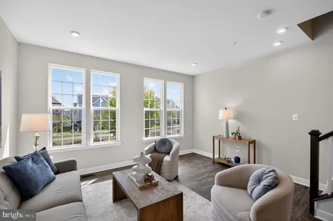 a living room with furniture a lamp and a large window