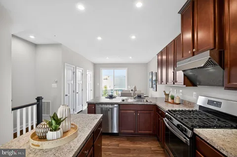 a kitchen with sink stove and cabinets