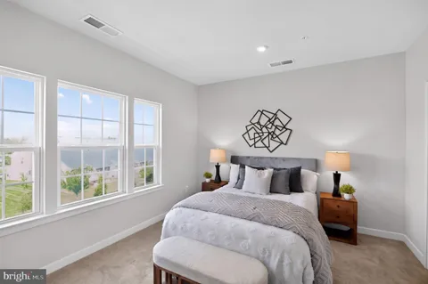 a bedroom with a bed and a large window