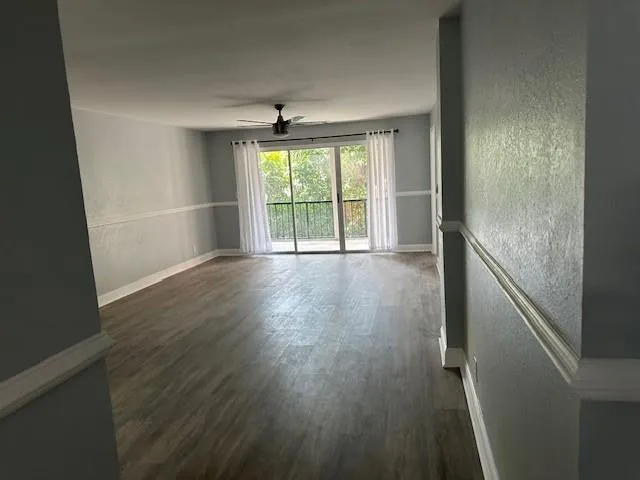 a kitchen with a refrigerator and white cabinets