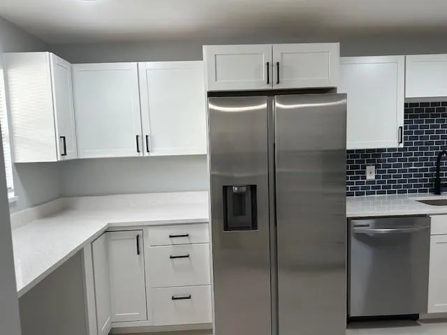 a view of an empty room with closet and a window