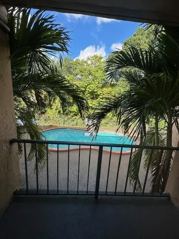 a view of a swimming pool with a yard