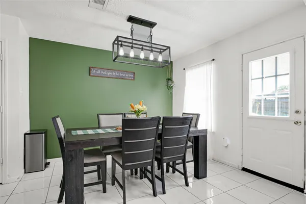 a view of a dining room with furniture and window