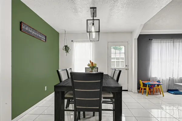a dining room with furniture and window