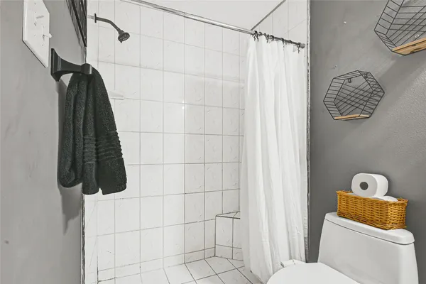 a bathroom with a toilet and shower