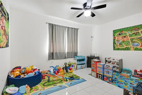 a play room with toys and a book shelf