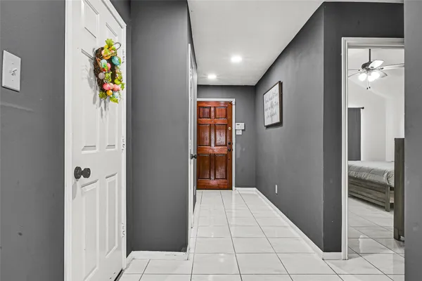 a view of hallway with wooden floor