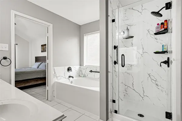 a bathroom with a bathtub and a shower