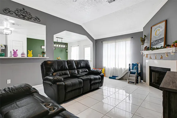 a living room with furniture and a fireplace