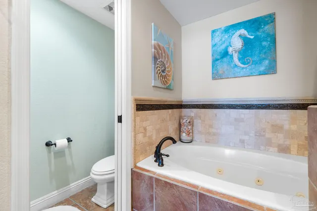 a bathroom with a bathtub and a toilet