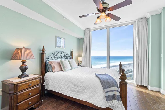 a bedroom with a bed and a chandelier