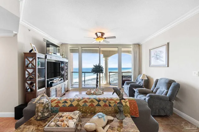 a living room with furniture a flat screen tv and a large window