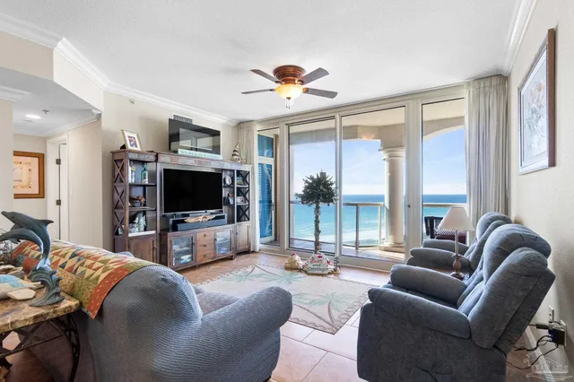 a living room with furniture a flat screen tv and a large window