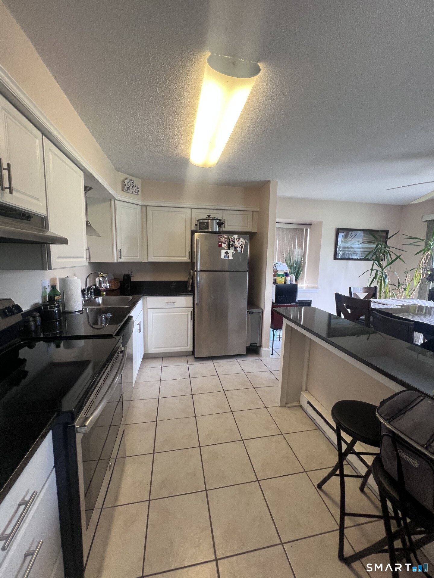 93 Kent Court, Unit 93 Meriden, CT 06450 - Photo 25 of 27 a kitchen with granite countertop a sink a counter top space stainless steel appliances and cabinets