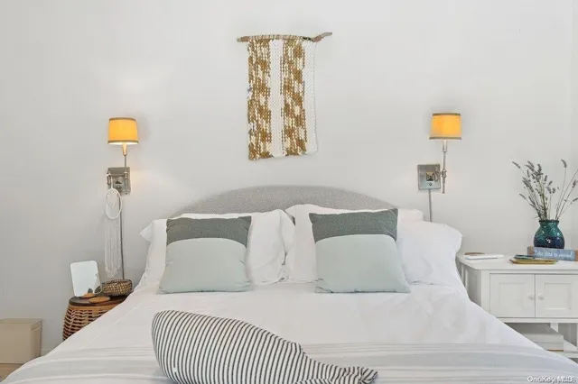 a living room with a couch and a potted plant