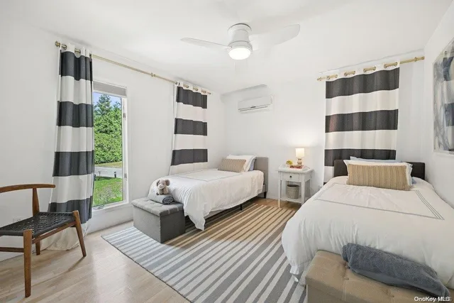 a bedroom with double bed and a window