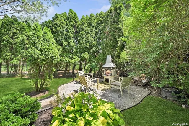 a view of a chair and table on the garden